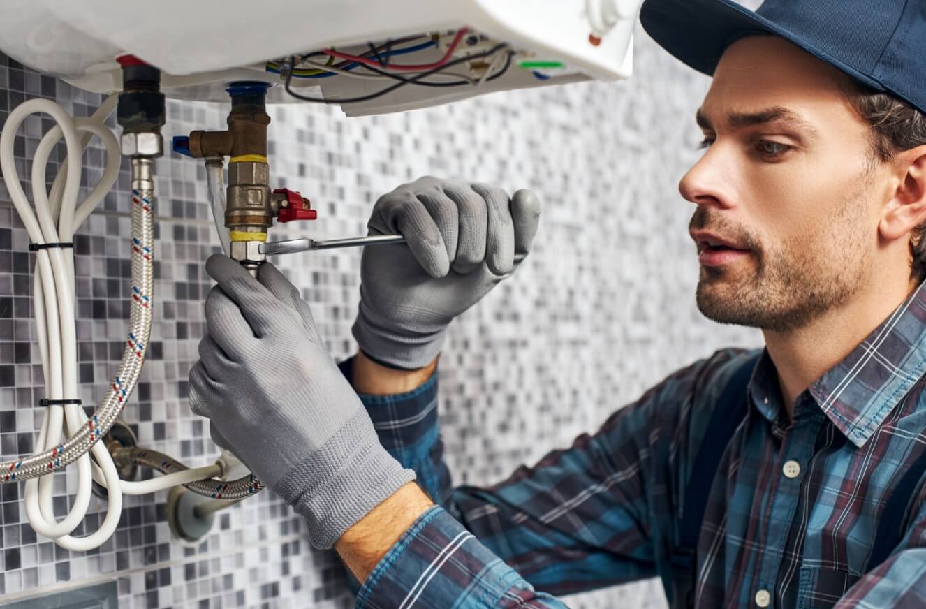 a man fixing a boiler after a boiler service cost quote