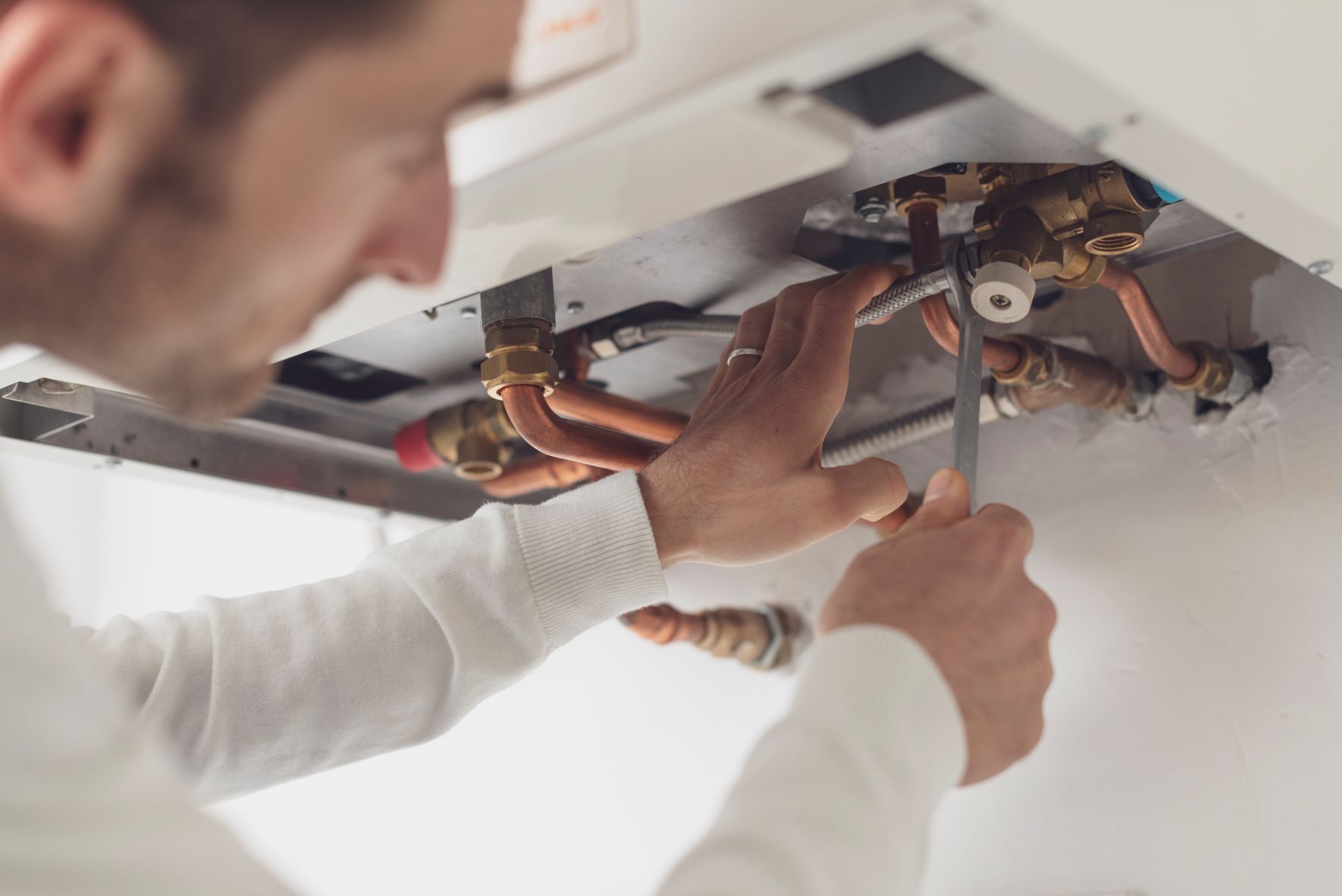 a plumber fixing a common intergas boiler fault